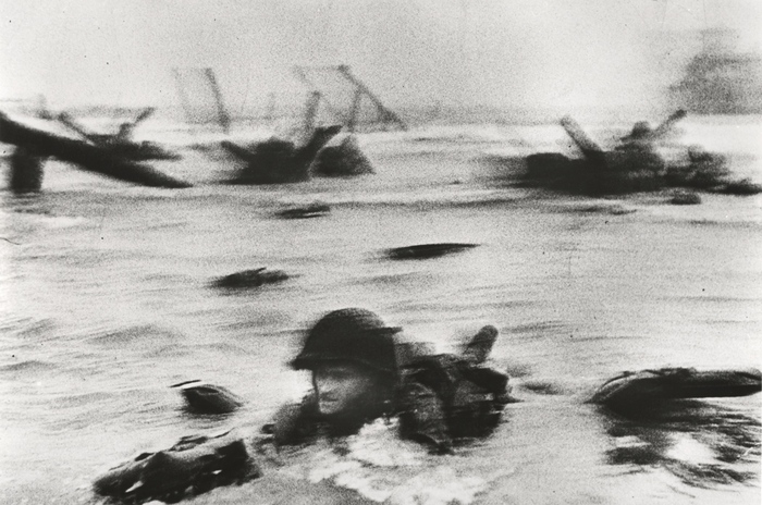 A D-napon az Omaha partszakaszon partra szálló amerikai csapatok. Colleville-sur-Mer közelében, Normandia, Franciaország, 1944. június 6. / © International Center of Photography/Magnum Photos Robert Capa Kortárs Fotográfiai Központ